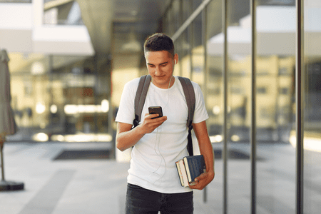 College student walking on campus next to study hall